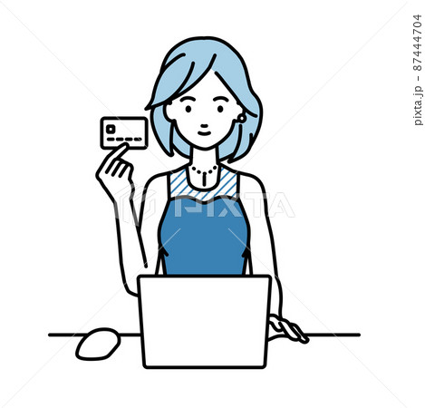 デスクで座ってPCを使いながらクレジットカードを手に持っているドレスの女性 デスクで座ってPCを使いながらクレジットカードを手に持っているドレスの女性 87444704