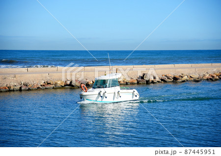 Fishing boat enters the marina  87445951