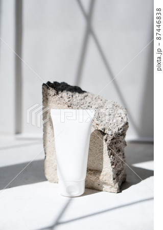 Clean white cream tube with trendy shadows and stone texture 87446838