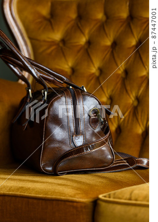 close-up photo of brown leather bag on a vintage sofa close-up photo of brown leather bag on a vintage sofa 87447001