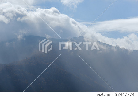 Morning foggy clouds in sunlight and autumn mountain countryside. Ukraine, Carpathian Mountains, Borzhava Range, Transcarpathia. Morning foggy clouds in sunlight and autumn mountain countryside. Ukraine, Carpathian Mountains, Borzhava Range, Transcarpathia. 87447774