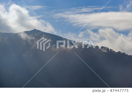 Morning foggy clouds in sunlight and autumn mountain countryside. Ukraine, Carpathian Mountains, Borzhava Range, Transcarpathia. Morning foggy clouds in sunlight and autumn mountain countryside. Ukraine, Carpathian Mountains, Borzhava Range, Transcarpathia. 87447775