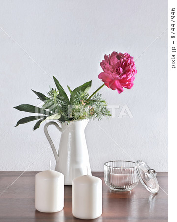 vertical of lifestyle interior decoration pink peony flower with candles on rustic wooden table. cozy home concept. morning light. spring flowers grown in a garden. vertical of lifestyle interior decoration pink peony flower with candles on rustic wooden table. cozy home concept. morning light. spring flowers grown in a garden. 87447946