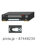 An analog VCR and videotape next to it. 87448230