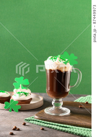 Irish coffee in green cup and special cupcakes for St Patrick s Day. 87449973