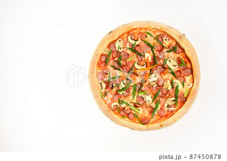 Spicy pizza with chili peppers. Pizza with sausages and mushrooms Spicy pizza with chili peppers. Pizza with sausages and mushrooms 87450878