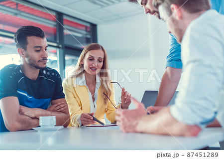 Football player with his lawyers and advisors negotiating transfer deal Football player with his lawyers and advisors negotiating transfer deal 87451289