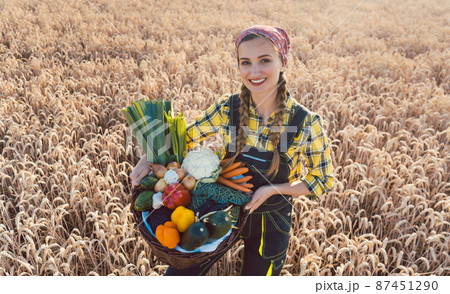 Farmer woman offering healthy vegetables 87451290