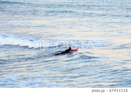 Surfer on board is surfing in sea 87451538