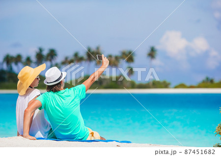 Young couple on white beach during summer vacation. Young couple on white beach during summer vacation. 87451682