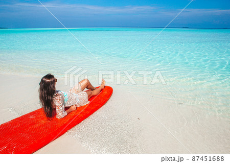 Woman surfing in the sea on vacation 87451688