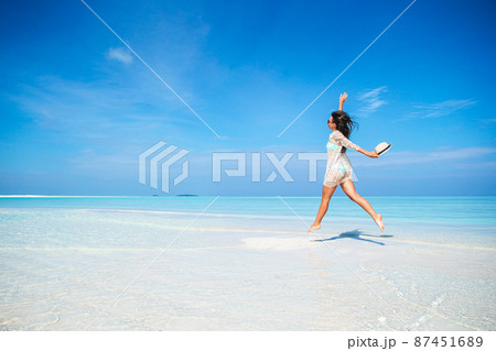 Young fashion woman in dress on the beach Young fashion woman in dress on the beach 87451689
