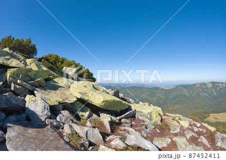 Rocky mountain hillside with big stone boulders on sunny day 87452411