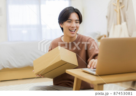 ダンボール パソコン 若い男性 87453081