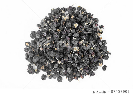 Black wolfberries or black goji berries heap. 87457902
