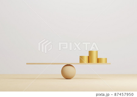 Money coin stack on wood scale seesaw and copy space 87457950