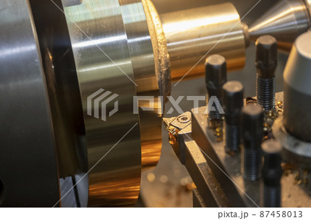 Closeup scene the lathe machine finishing cut the brass shaft parts by lathe tools. Closeup scene the lathe machine finishing cut the brass shaft parts by lathe tools. 87458013