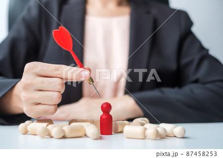 Hand holding dart over red people.Goal, target, aim, objective, leadership, Business and marketing concept 87458253