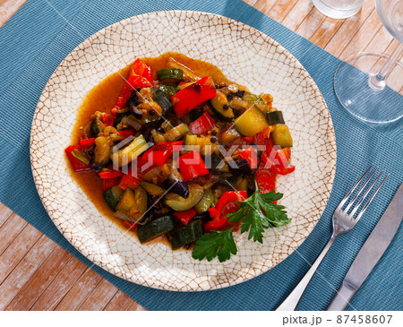 Platter of stewed vegetables - bell pepper, zucchini 87458607