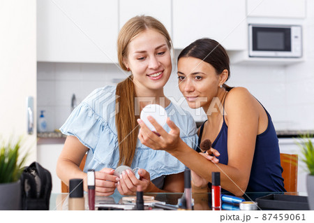 Women friends talking and applying make up Women friends talking and applying make up 87459061