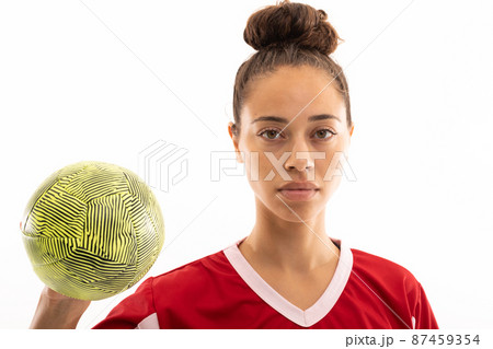 Close-up portrait of confident biracial young female player with handball against white background 87459354