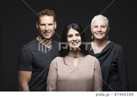 Studio portrait of three smiling people 87460390