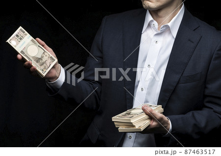 札束を手に持っている男性 87463517