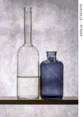 Still life with glass dishes on a wooden shelf Still life with glass dishes on a wooden shelf 87463648