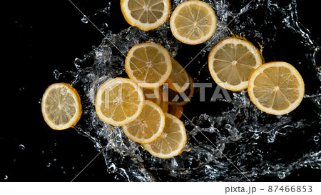 Freeze motion of sliced lemons in water splash. 87466853