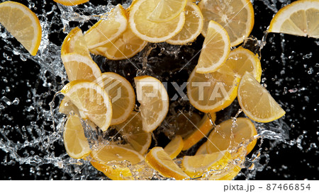 Freeze motion of sliced lemons in water splash. 87466854