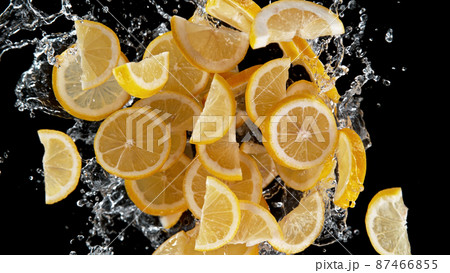 Freeze motion of sliced lemons in water splash. 87466855