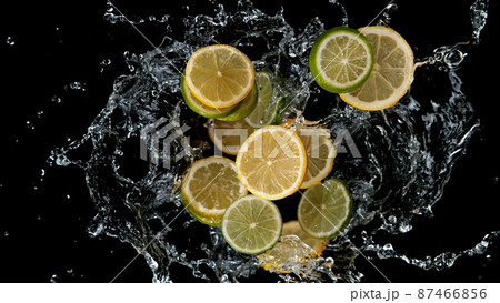 Freeze motion of sliced limes and lemons in water splash. 87466856