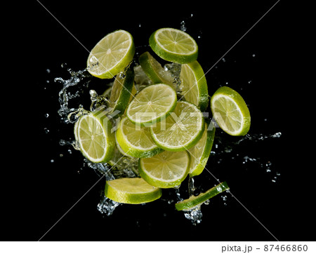 Freeze motion of sliced limes in water splash. 87466860