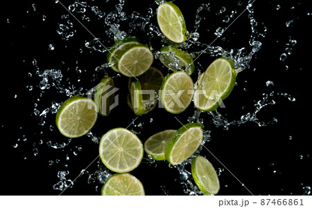 Freeze motion of sliced limes in water splash. 87466861