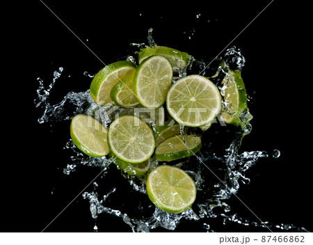 Freeze motion of sliced limes in water splash. 87466862
