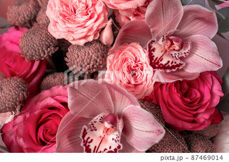 Bright pink flowers bouquet closeup. Roses and orchids wallpaper. Beautiful background for a Birthday, International Female Day, or Saint Valentine. The festive backdrop for a postcard design Bright pink flowers bouquet closeup. Roses and orchids wallpaper. Beautiful background for a Birthday, International Female Day, or Saint Valentine. The festive backdrop for a postcard design 87469014
