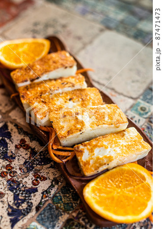 Grilled Halloumi Cheese on a plate with herbs. Top view Grilled Halloumi Cheese on a plate with herbs. Top view 87471473