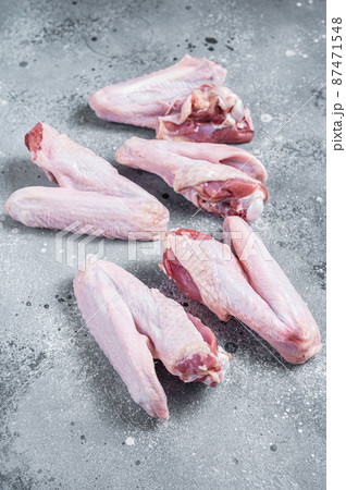 Fresh raw duck wings on kitchen table. Gray background. Top view Fresh raw duck wings on kitchen table. Gray background. Top view 87471548