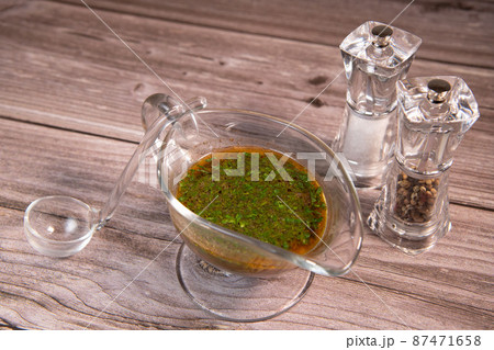 Devil's sauce in a transparent glass sauce boat, salt and pepper shaker 87471658
