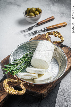 Goat soft cheese chevre in a skillet. White background. Top view Goat soft cheese chevre in a skillet. White background. Top view 87471679