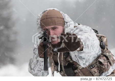 Soldier in winter camouflaged uniform in Modern warfare army on a snow day on forest battlefield with a rifle. Model face very similar to Ukraine prime minister. Soldier in winter camouflaged uniform in Modern warfare army on a snow day on forest battlefield with a rifle. Model face very similar to Ukraine prime minister. 87472725