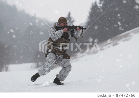 Soldier in winter camouflaged uniform in Modern warfare army on a snow day on forest battlefield with a rifle. Model face very similar to Ukraine prime minister. Soldier in winter camouflaged uniform in Modern warfare army on a snow day on forest battlefield with a rifle. Model face very similar to Ukraine prime minister. 87472766