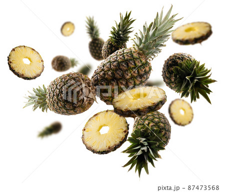 Ripe pineapples levitate on a white background Ripe pineapples levitate on a white background 87473568