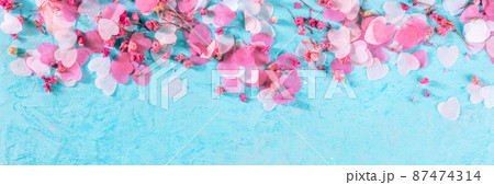 Valentine day or wedding panorama with pink hearts and flowers confetti Valentine day or wedding panorama with pink hearts and flowers confetti 87474314