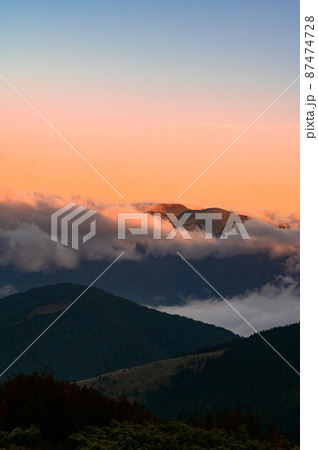 Petros Mountain in the morning fog, overcast mountain range at dawn, the magical mountains of Ukraine. Petros Mountain in the morning fog, overcast mountain range at dawn, the magical mountains of Ukraine. 87474728