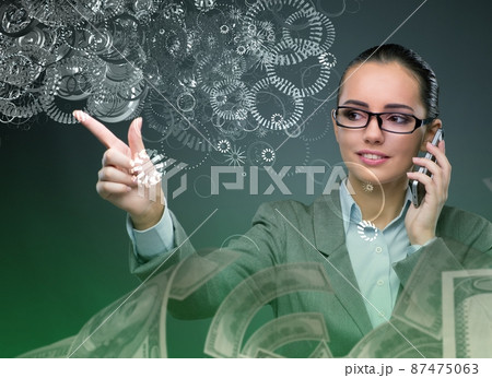 Businesswoman with dollars talking on mobile phone Businesswoman with dollars talking on mobile phone 87475063