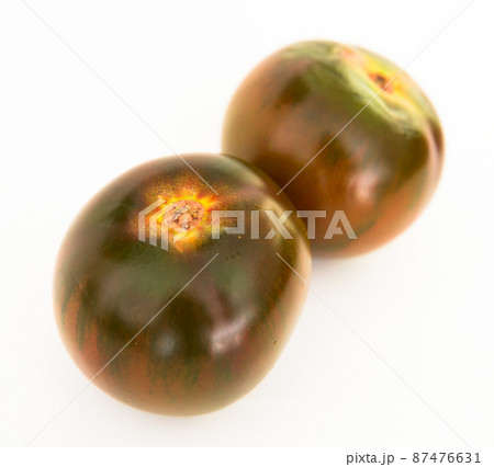 ripe black tomatoes on a white background 87476631