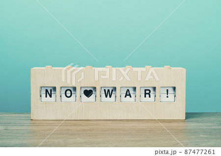 text no war in a wooden split flap board 87477261