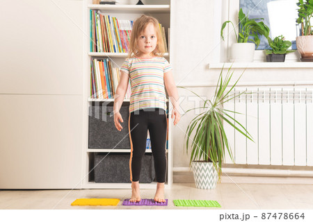 Little girl exercising at home. Physical and mental health trend 87478664