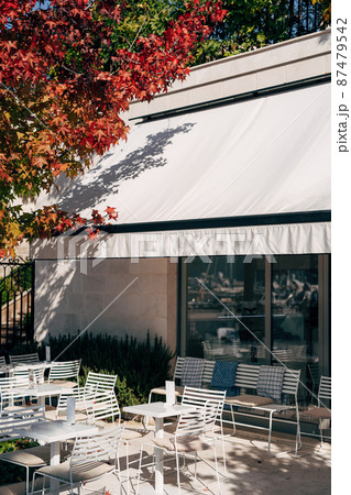 Tables and chairs are on the tiles outside the restaurant. Porto. Montenegro 87479542